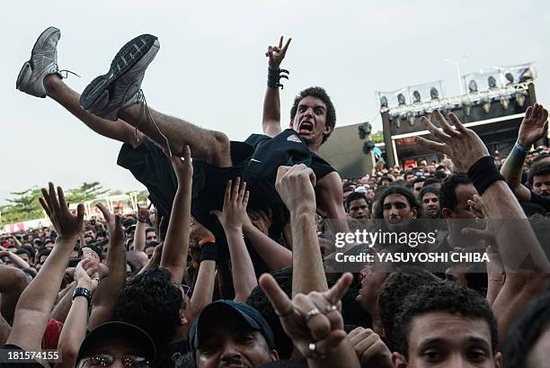 Man is held up by the audience during Rock in Rio music festival in Rio de Janeiro, Brazil, on September 22, 2013. Rock in Rio announced there will...