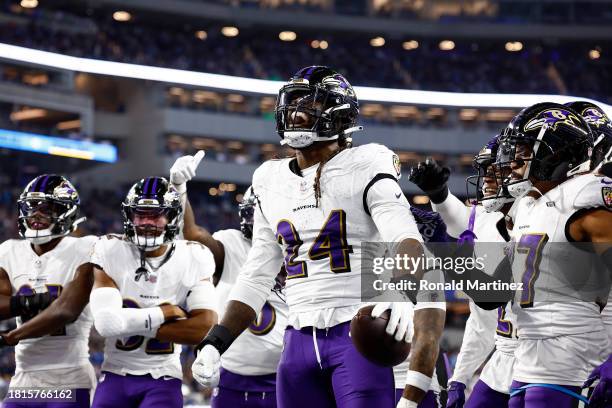 Jadeveon Clowney of the Baltimore Ravens celebrates with his teammates after recovering a fumble against the Los Angeles Chargers during the fourth...