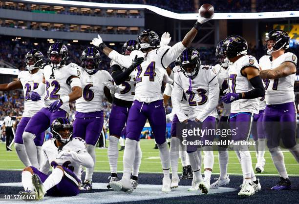 Jadeveon Clowney of the Baltimore Ravens celebrates with his teammates after recovering a fumble against the Los Angeles Chargers during the fourth...