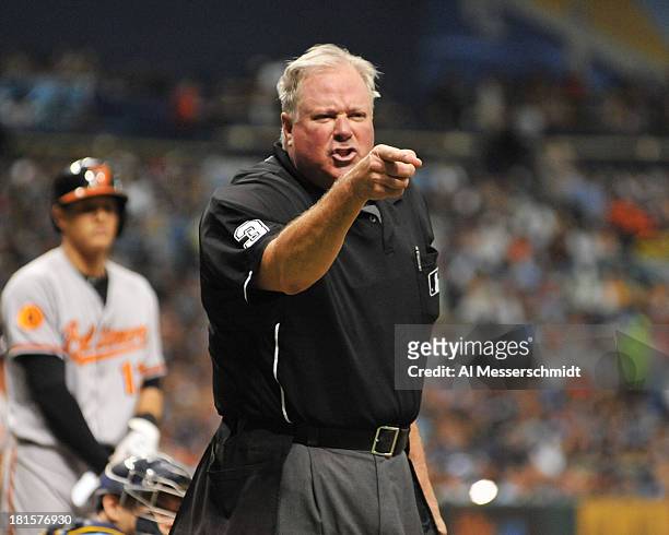 Home plate umpire Tim Welke points to manager Joe Maddon of the Tampa Bay Rays during play against the Baltimore Orioles September 22, 2013 at...