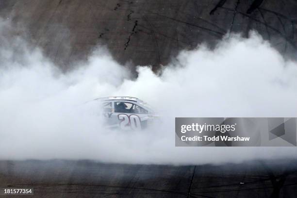 Matt Kenseth, driver of the Home Depot / Husky Toyota, celebrates with a burnout after winning the NASCAR Sprint Cup Series Sylvania 300 at New...