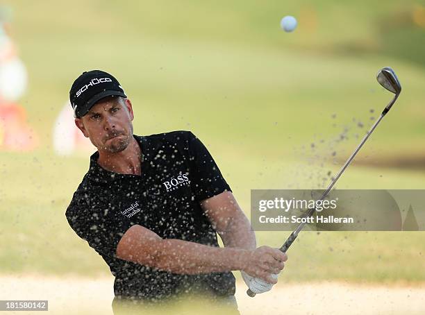 Henrik Stenson of Sweden plays a bunker shot on the 18th hole during the final round of the TOUR Championship by Coca-Cola at East Lake Golf Club on...