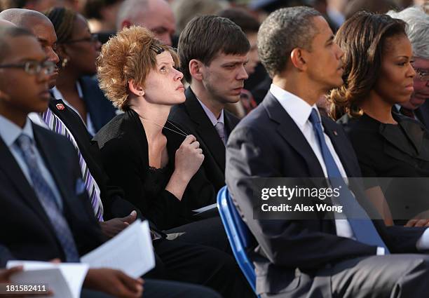 Family members mourn their loss as they attend a memorial service for victims of the Washington Navy Yard shooting at the Marine Barracks September...