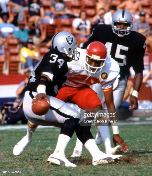 Los Angeles Raiders Running Back Bo Jackson is stopped by Chiefs Albert Lewis during game action of LA Raiders against Kansas City Chiefs, October 9,...