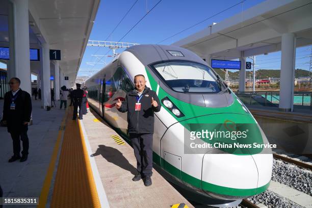 Man takes photos in front of the first train from Shangri-La to Lijiang on November 26, 2023 in Shangri-La, Diqing Tibetan Autonomous Prefecture,...
