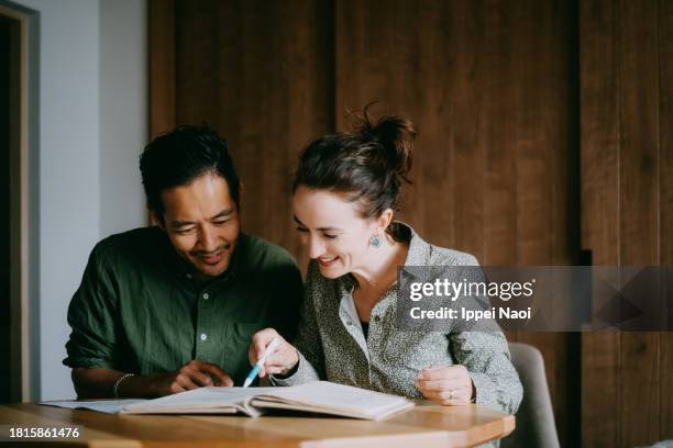 happy couple planning their future home - smile drawing stock pictures, royalty-free photos & images