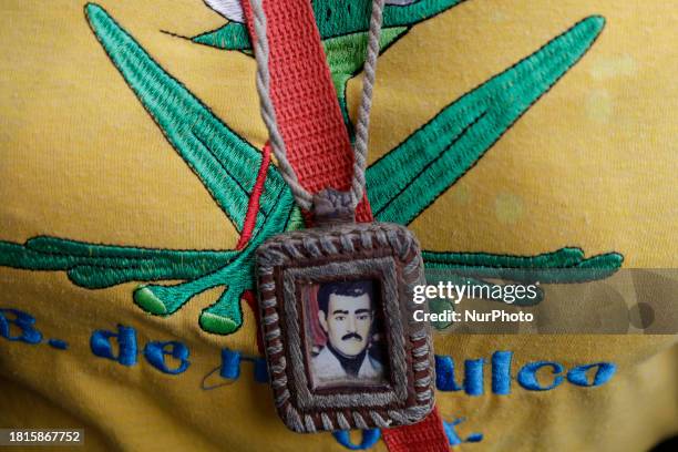 An image of Jesus Malverde, known as the patron saint of drug traffickers in Mexico, is being viewed.