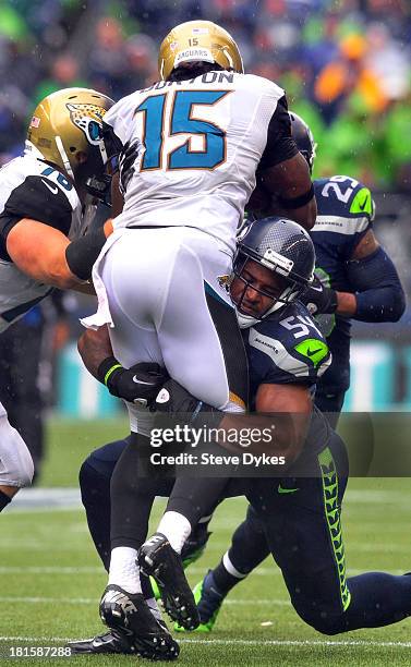 Wide receiver Stephen Burton of the Jacksonville Jaguars is brought down by middle linebacker Bobby Wagner of the Seattle Seahawks during the second...