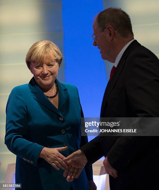 German Chancellor and candidate for the Christian Democratic Union Angela Merkel shakes hands with the Social Democratic party's candidate Peer...