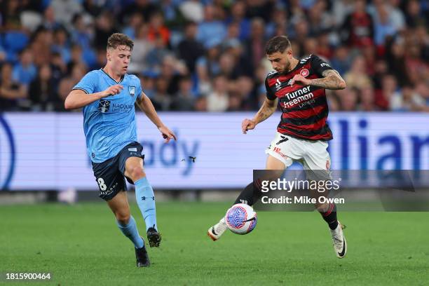 Dylan Pierias of the Wanderers runs with the ball whilst under pressure Jake Girdwood-Reich of Sydney FC during the A-League Men round five match...