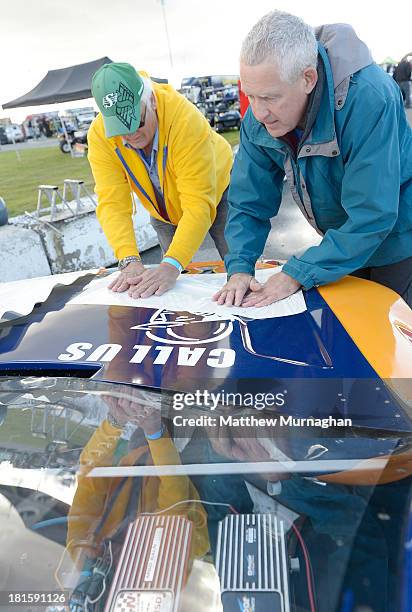 Joey McColm, driver of the No. 50 Canada's Best Store Fixtures/Espar Dodge pit crew applies the hood decal during the NASCAR Canadian Tire Series...