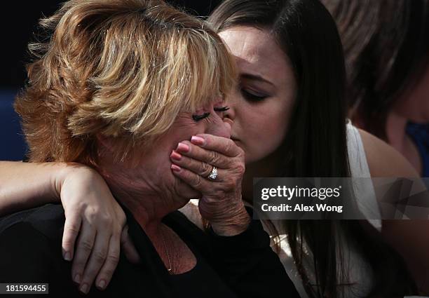 Family members mourn their loss as they attend a memorial for victims of the Washington Navy Yard shooting at the Marine Barracks September 22, 2013...