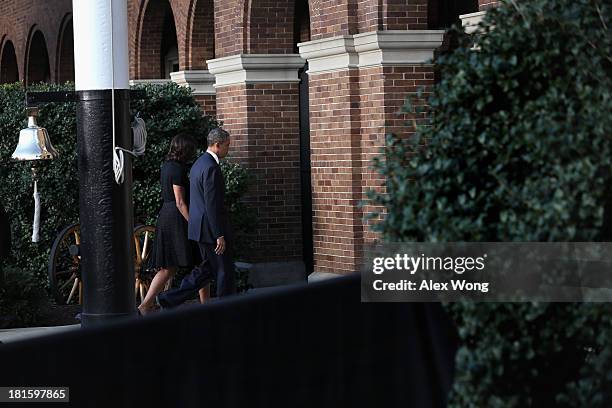 President Barack Obama and first lady Michelle Obama leave after a memorial service for victims of the Washington Navy Yard shooting at the Marine...