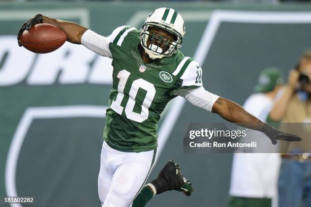 Wide receiver Santonio Holmes of the New York Jets celebrates after his 69 yard touchdown catch in the 2nd half of the Jets 27-20 win over the...
