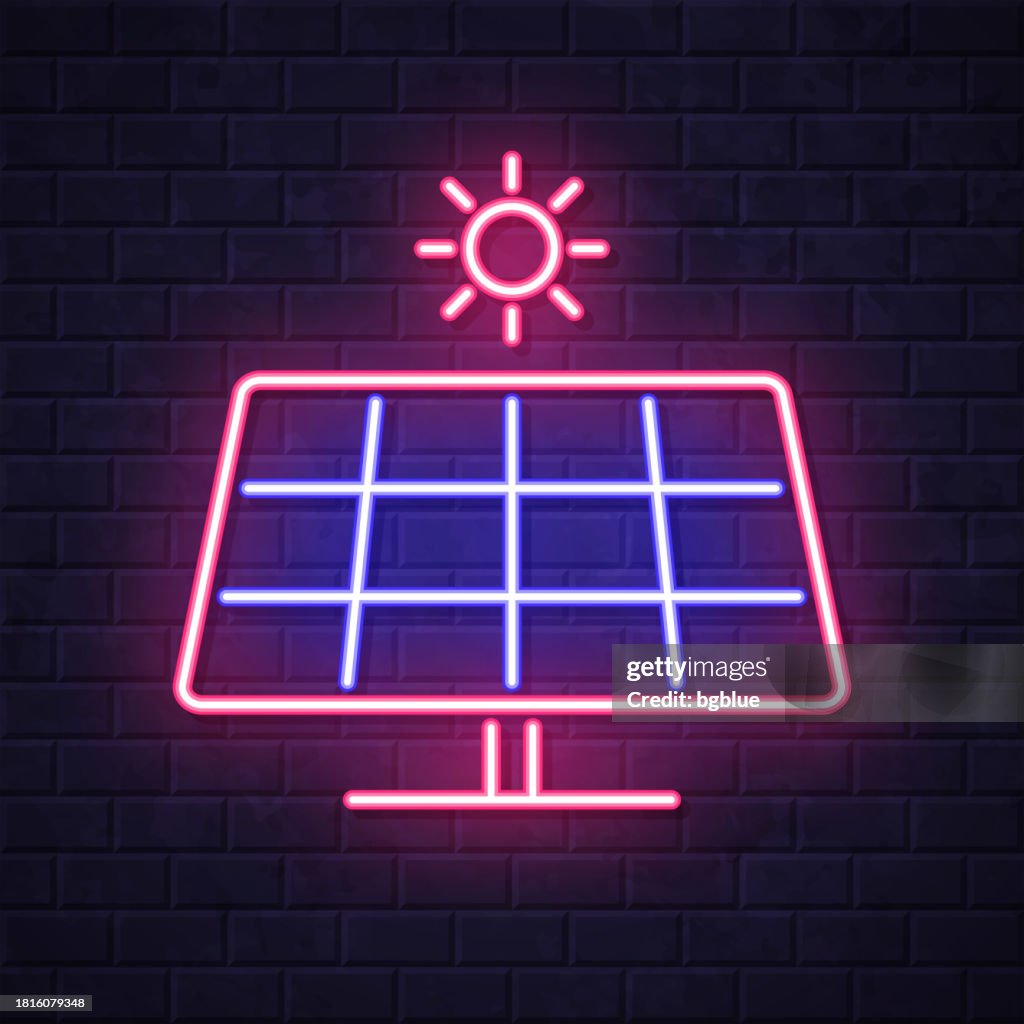 Solar panel with sun. Glowing neon icon on brick wall background