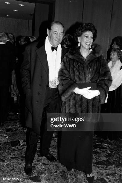 Rex Harrison and Mercia Tinker attend a party in Washington, D.C., on December 7, 1981.