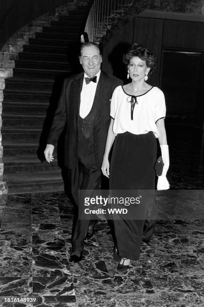 Rex Harrison and Mercia Tinker attend a party in Washington, D.C., on December 7, 1981.