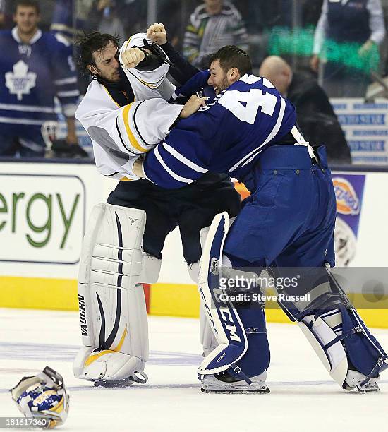 Buffalo Sabres goalie Ryan Miller and Toronto Maple Leafs goalie Jonathan Bernier fight in the third period as the Toronto Maple Leafs beat the...