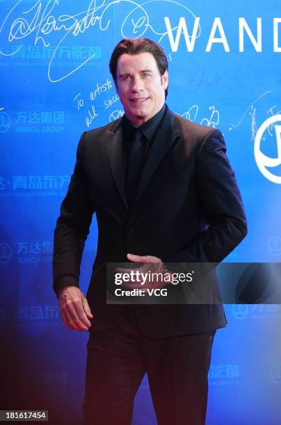 Actor John Travolta arrives on the red carpet during the opening night of the Qingdao Oriental Movie Metropolis at Qingdao Beer City on September 22,...