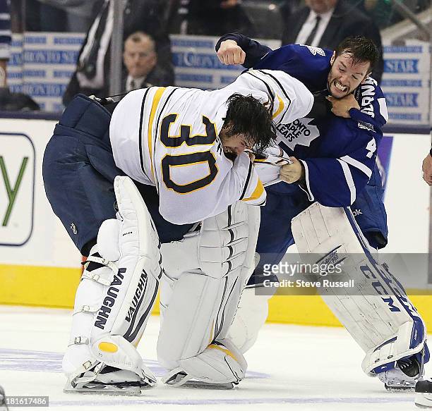 Buffalo Sabres goalie Ryan Miller and Toronto Maple Leafs goalie Jonathan Bernier fight in the third period as the Toronto Maple Leafs beat the...