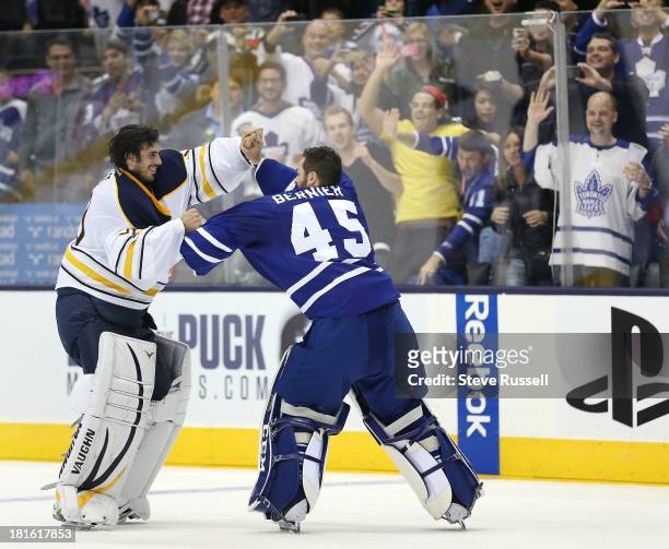 Buffalo Sabres goalie Ryan Miller and Jonathan Bernier fight in the third period as the Toronto Maple Leafs beat the Buffalo Sabres 5-3 in preseason...