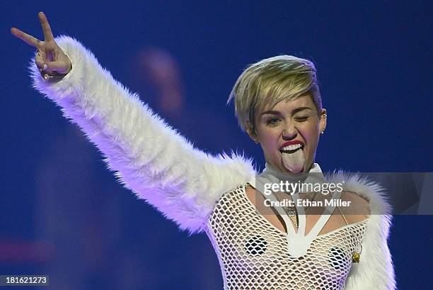 Entertainer Miley Cyrus winks and sticks out her tongue as she performs during the iHeartRadio Music Festival at the MGM Grand Garden Arena on...