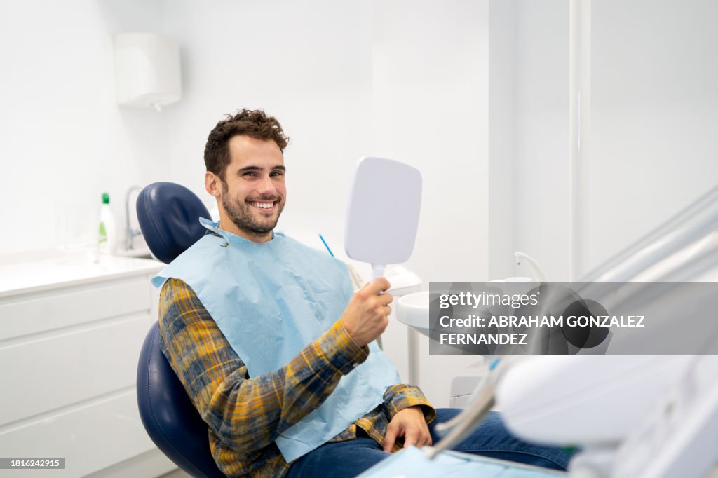 Satisfied man after a whitening procedure in a dental clinic