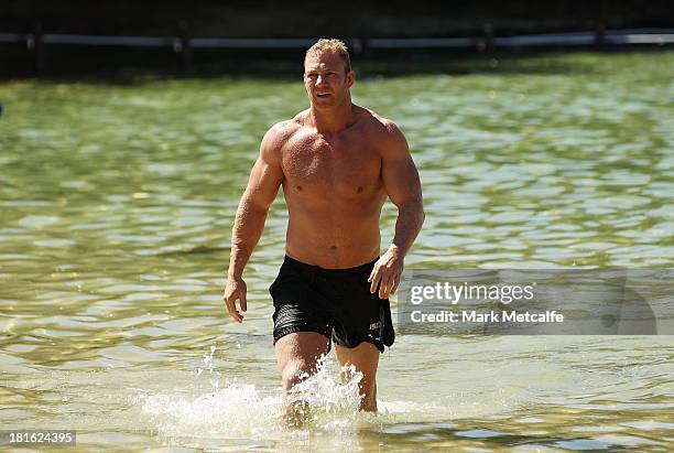 Michael Crocker walks from the ocean during a South Sydney Rabbitohs NRL recovery session at Clovelly Beach on September 23, 2013 in Sydney,...