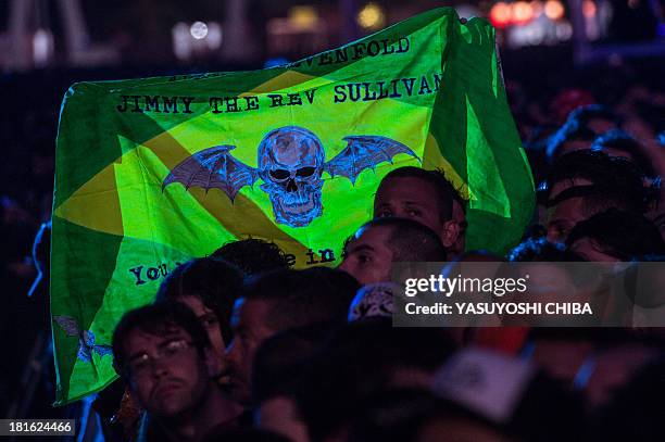 Fan of American heavy metal band Avenged Sevenfold holds a flag during the final day of the Rock in Rio music festival in Rio de Janeiro, Brazil, on...