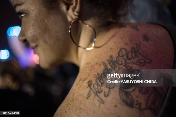 Adriana Carneiro, Brazilian 41-year-old who made a tattoo of American Brithish heavy metal band Iron Maiden for her husband, waits for the stage of...