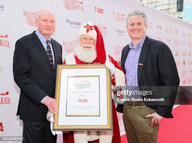 James B. Laster and Chris Cocks, CEO of Hasbro attend the 91st anniversary of the Hollywood Christmas Parade, supporting Marine Toys For Tots on...