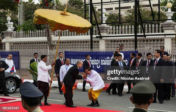 King Sihamoni greets Prime Minister Hun Sen on arrival for the first day of Parliament despite an opposition boycott on September 23, 2013 in Phnom...