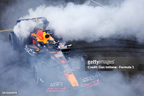Race winner Max Verstappen of the Netherlands driving the Oracle Red Bull Racing RB19 performs donuts on track at the end of the F1 Grand Prix of Abu...