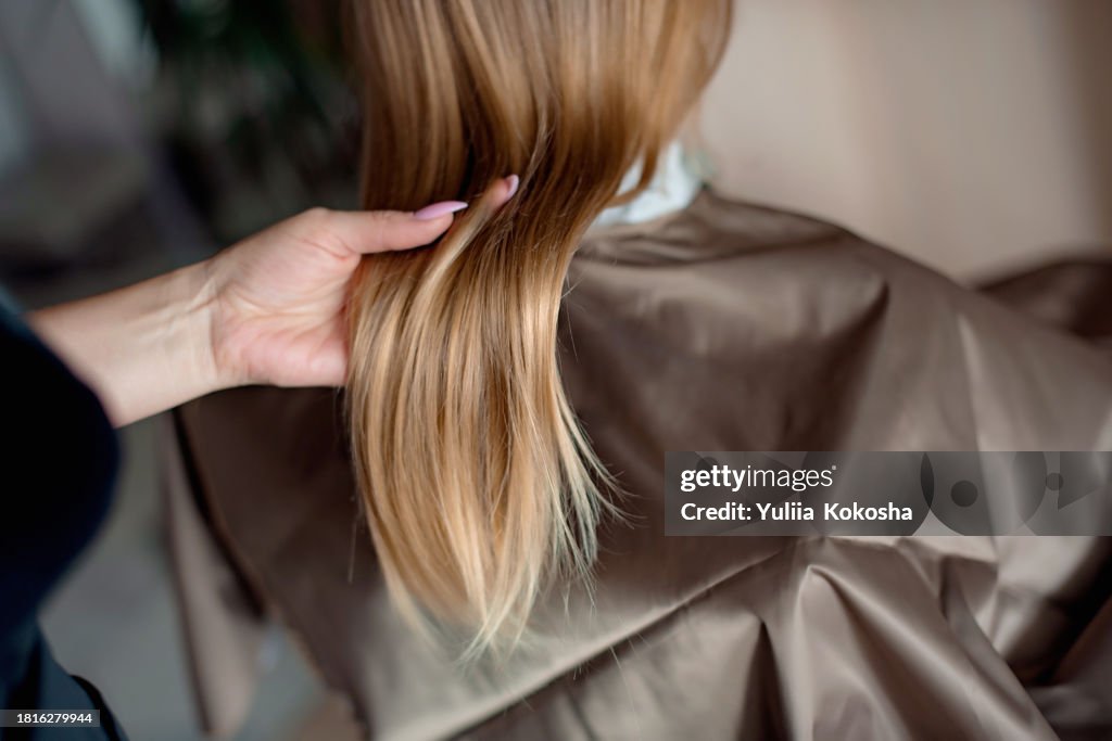 Woman having haircut in salon