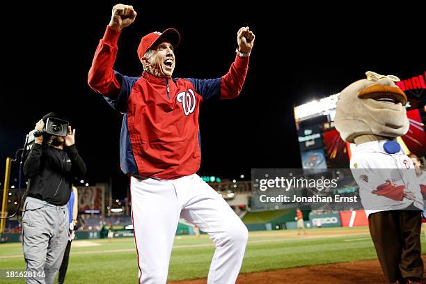 Manager Davey Johnson of the Washington Nationals reacts with fans after his team's walk-off 5-4 win over the Miami Marlins in the ninth inning of...