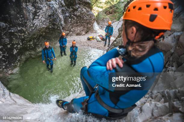 caucasian woman sliding at canyoning - slovenia spring stock pictures, royalty-free photos & images