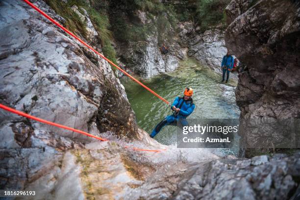 canyoning adventure with caucasian male - rock climbing equipment stock pictures, royalty-free photos & images