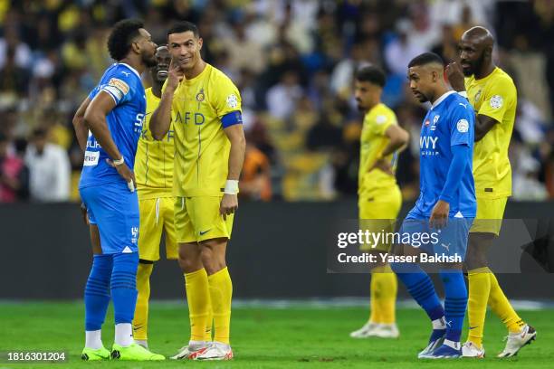 Ali Al Buliahi of Al Hilal and Cristiano Ronaldo of Al Nassr fight during the Saudi Pro League match between Al-Hilal and Al-Nassr at King Fahd...