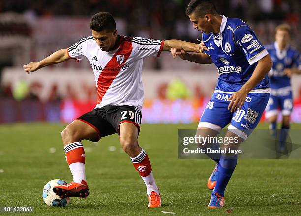 Teofilo Gutierrez, of River Plate, and Nehuen Paz, of All Boys, fight for the ball during a match between River Plate and All Boys as part of the...