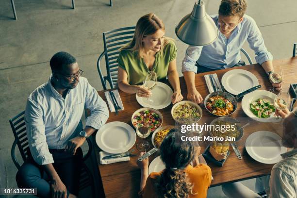 business meeting in an elegant restaurant. - luxury home dining table people lifestyle photography people stock pictures, royalty-free photos & images