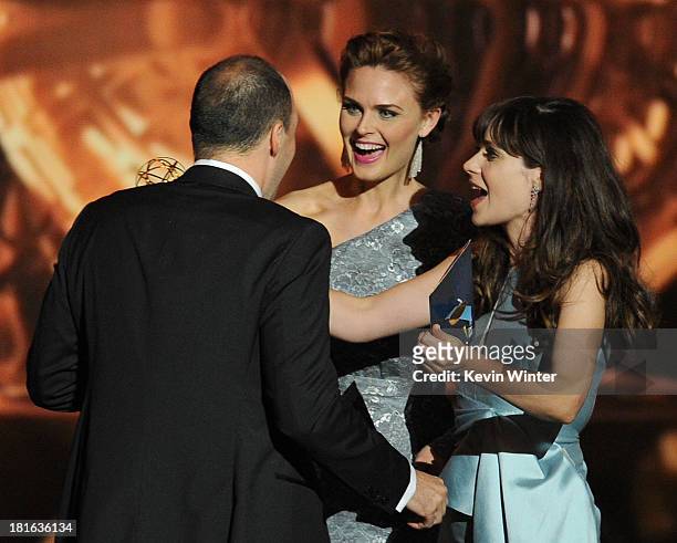 Actor Tony Hale recieves an award from actresses Emily Deschanel and Zooey Deschanel onstage during the 65th Annual Primetime Emmy Awards held at...
