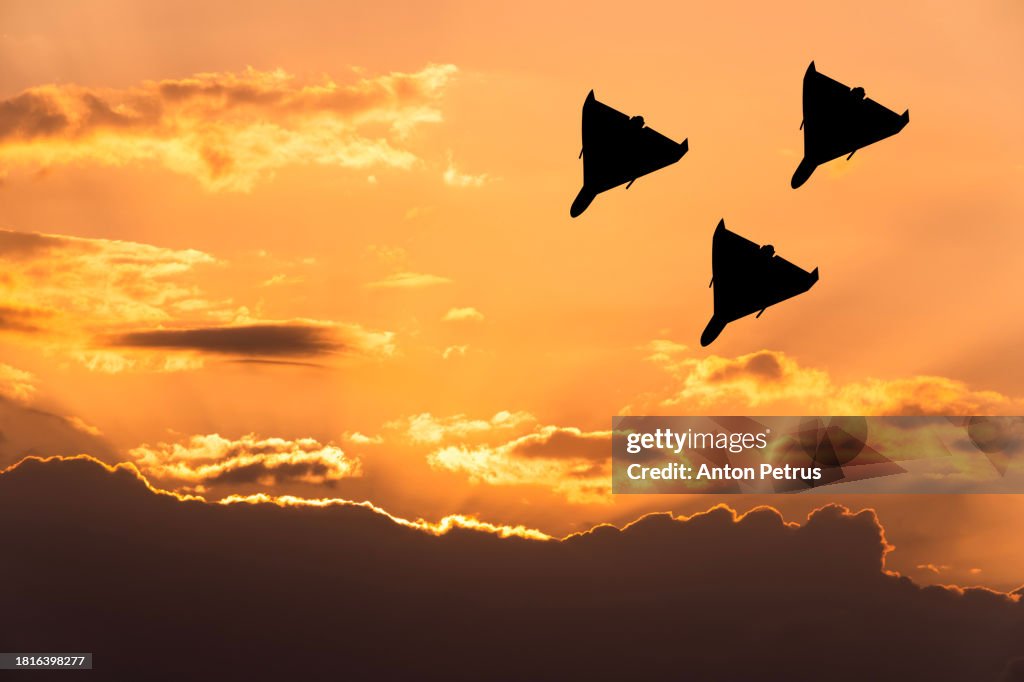 Kamikaze drones against the sunset sky
