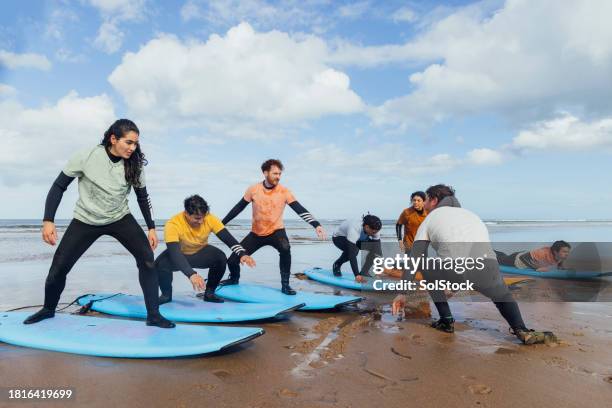 learning to surf - extreme sports equipment stock pictures, royalty-free photos & images