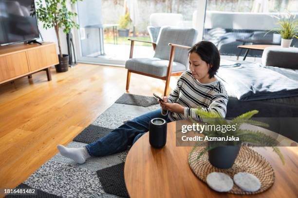 cozy afternoon with smart home entertainment - smart speaker stock pictures, royalty-free photos & images