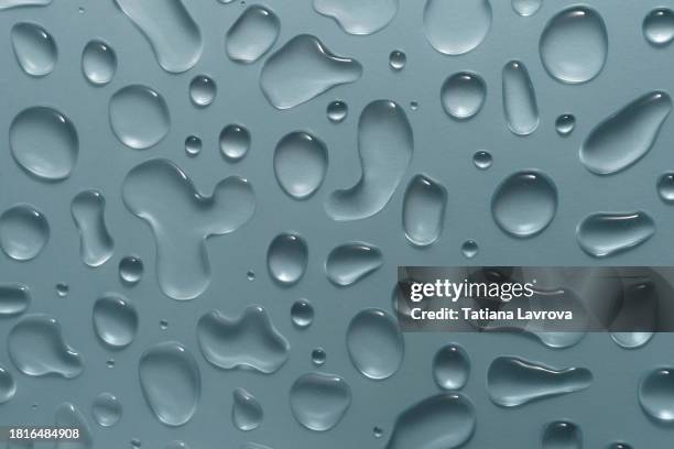 beautiful drops of water on matte glass surface making natural pattern.skin care, wellness, hydration, moisturizing beauty cosmetics with copy space. - liquid drop stock pictures, royalty-free photos & images