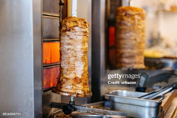 gyros meat being grilled on a skewer at a fast food kiosk - doner kebab stock pictures, royalty-free photos & images