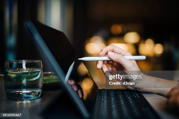 close-up shot of female hand using digital tablet with digitized pen on the table. businesswoman working on digital tablet in office. business lifestyle and digital technology - illustrator stock pictures, royalty-free photos & images