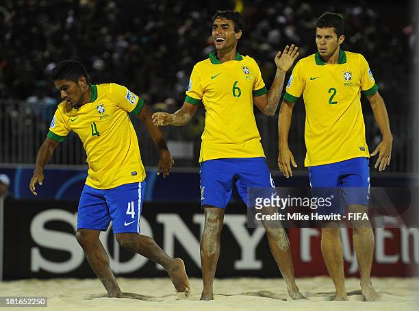 Bruno of Brazil celebrates after scoring with team mates Eudin and Fernando during the FIFA Beach Soccer World Cup Tahiti 2013 Group C match between...