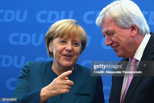 German Chancellor and Chairwoman of the German Christian Democrats Angela Merkel reacts with prime minister of hesse Volker Bouffier prior a meeting...