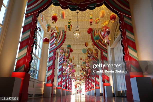 Candy-themed ornaments hang from the ceiling of the hallway between the East Wing and the Residence during a media preview of the holiday decorations...